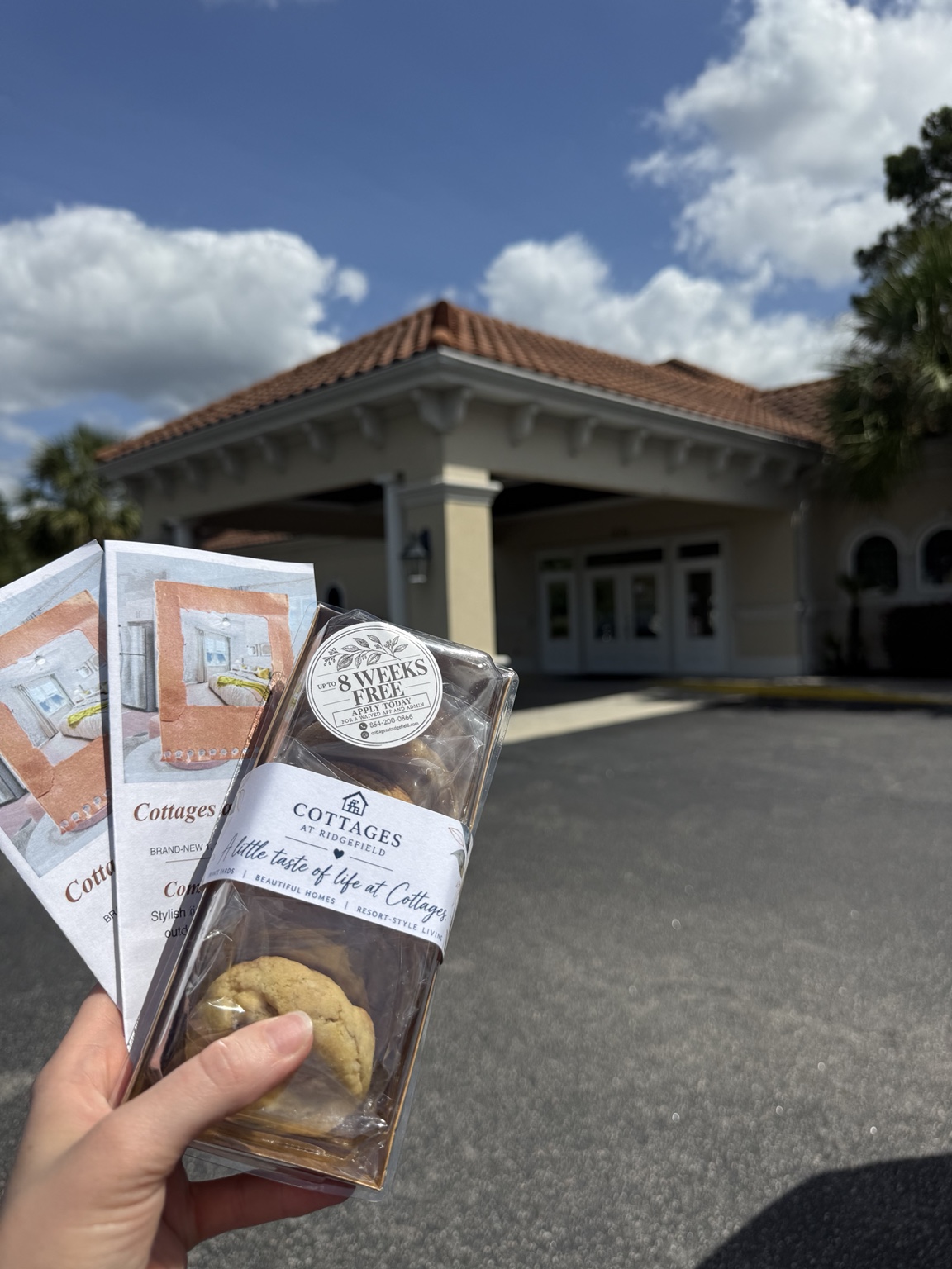 A finished cookie box and leasing flyers being carried to a local outreach visit